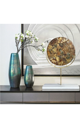 Large brown decorative disc with ammonites on a gold stand and white marble