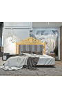 Baroque bed headboard with black and white striped fabric and gilded wood