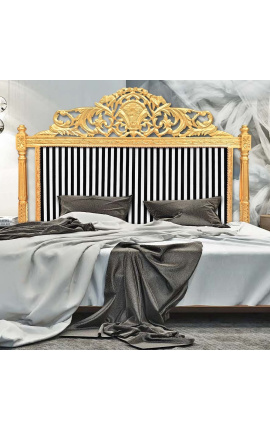 Baroque bed headboard with black and white striped fabric and gilded wood