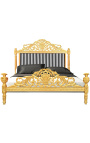 Łóżko w stylu barokowym z tkaniną w czarno-białe paski i złoconym drewnem