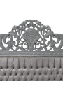 Łóżko w stylu barokowym z szarą aksamitną tkaniną i szarym lakierowanym drewnem.