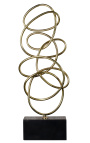 Duża rzeźba mosiężnych spirali na marmurowej podstawie