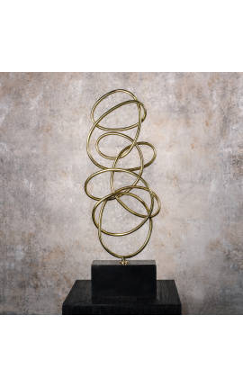 Large sculpture of brass spirals on marble base