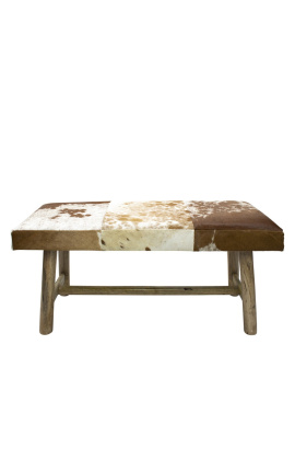 Banc en bois et peau de vache marron et blanc