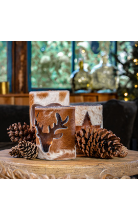 Brown and white cowhide candle holder with deer decoration