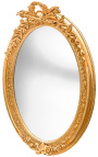 Very large golden vertical oval baroque mirror