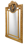 Grand miroir à parcloses de style Louis XVI doré profil feminin