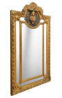 Grand miroir à parcloses de style Louis XVI doré profil feminin