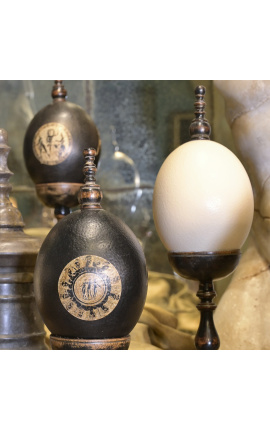 Ostrich egg on wooden baluster with square base