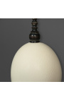 Uovo di struzzo su colonnina in legno a base quadrata