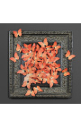 Czarna, patynowana, XIX-wieczna rama z lotem pomarańczowych motyli