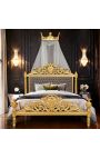 Cama con dosel en madera dorado, patinado tallado en forma de corona