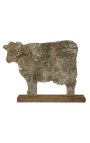 cow on wooden stand with bark and knot rope