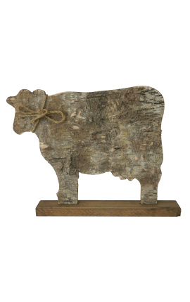 cow on wooden stand with bark and knot rope